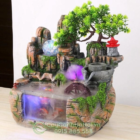 Tiểu cảnh thác nước mini để bàn với dòng nước nhỏ chảy giữa đá và cây xanh